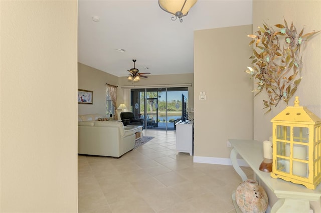 living room featuring light tile patterned floors and ceiling fan