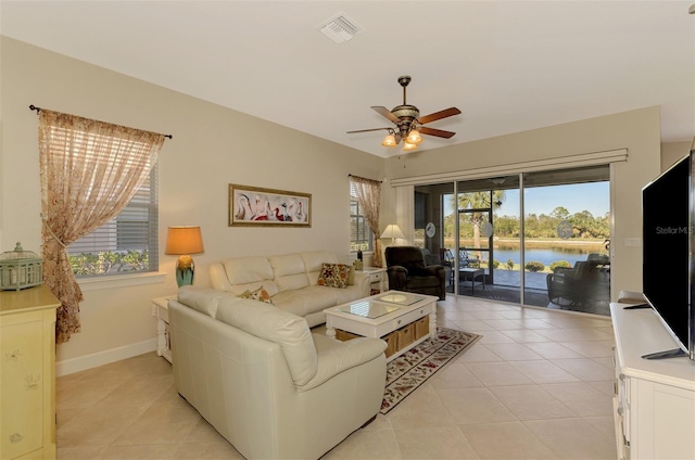 tiled living room featuring ceiling fan and a healthy amount of sunlight