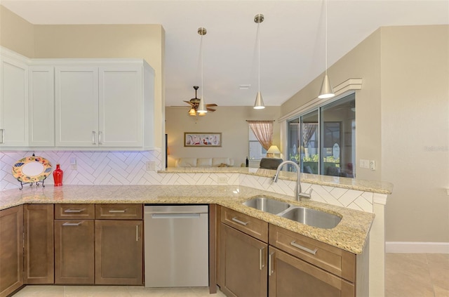 kitchen featuring dishwasher, white cabinets, sink, ceiling fan, and light stone counters