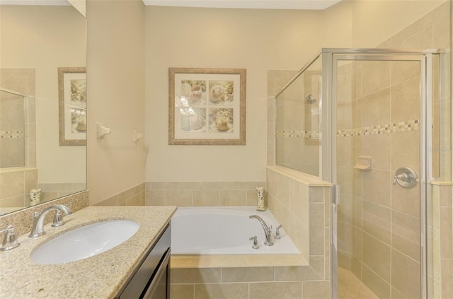 bathroom featuring shower with separate bathtub and vanity