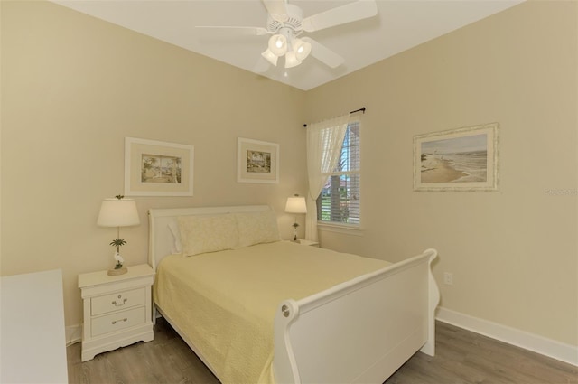 bedroom with dark hardwood / wood-style floors and ceiling fan