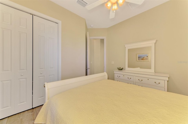 bedroom with ceiling fan, light wood-type flooring, and a closet