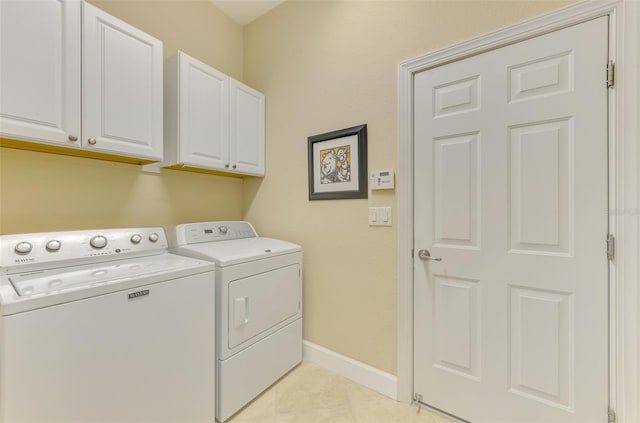 washroom featuring cabinets and washing machine and dryer