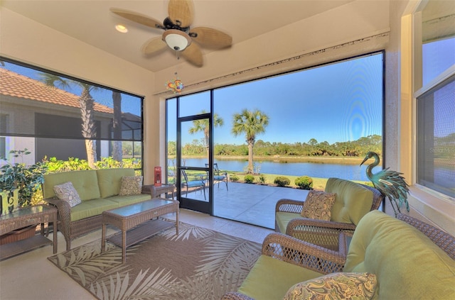 sunroom with a water view and ceiling fan