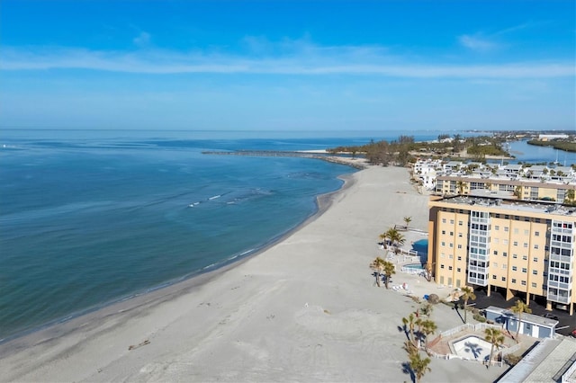 birds eye view of property with a water view and a beach view