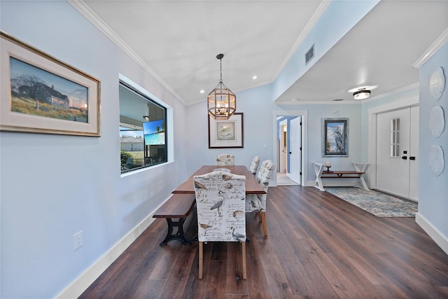 dining area with dark hardwood / wood-style flooring, a notable chandelier, and ornamental molding