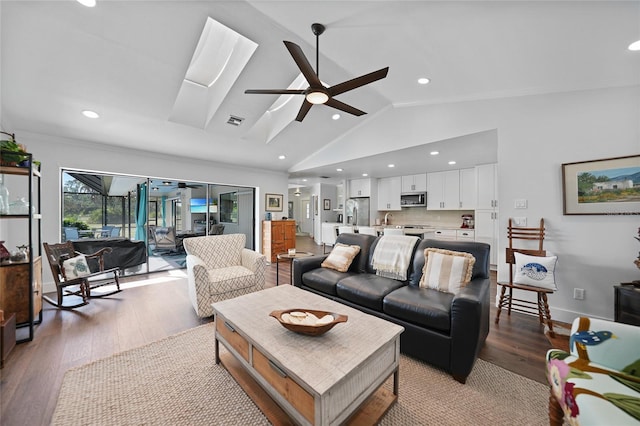 living room with light hardwood / wood-style flooring, vaulted ceiling, ceiling fan, and ornamental molding