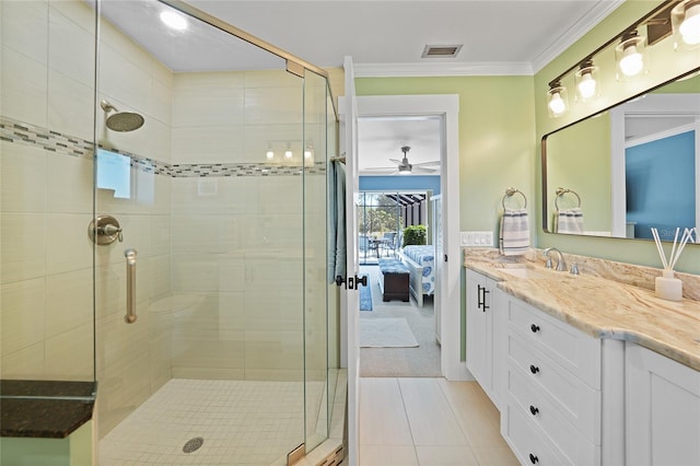 bathroom featuring an enclosed shower, vanity, ceiling fan, crown molding, and tile patterned flooring