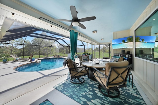 view of swimming pool featuring glass enclosure, ceiling fan, and a patio area