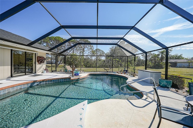 view of pool featuring glass enclosure and a patio area