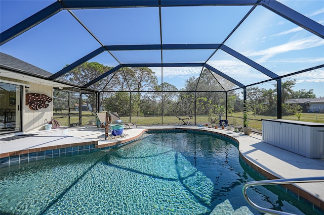 view of swimming pool featuring a lanai and a patio area