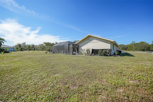 view of property exterior with a lawn and a lanai