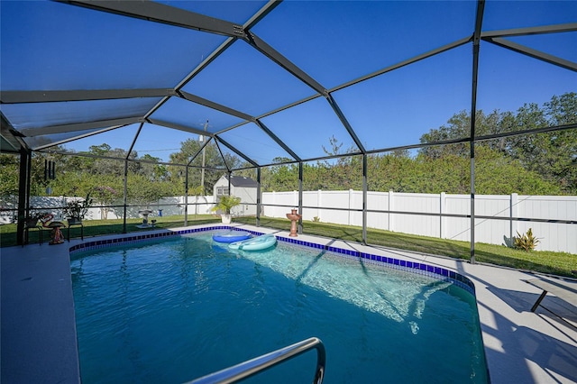 view of pool featuring a yard and glass enclosure