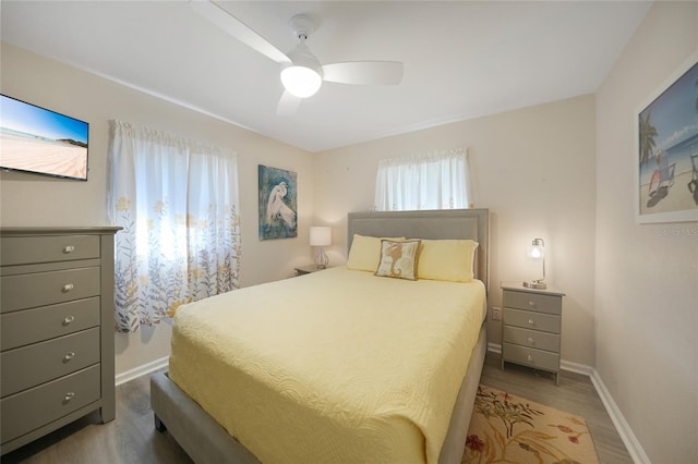 bedroom with dark hardwood / wood-style floors and ceiling fan