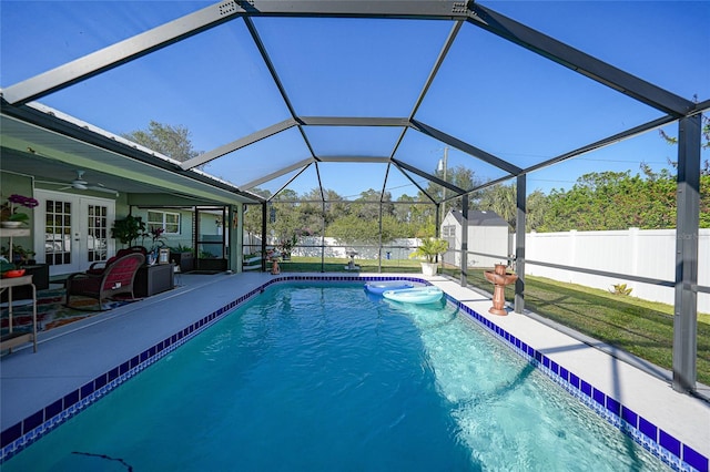 view of swimming pool featuring a patio area, a lanai, a storage shed, and french doors