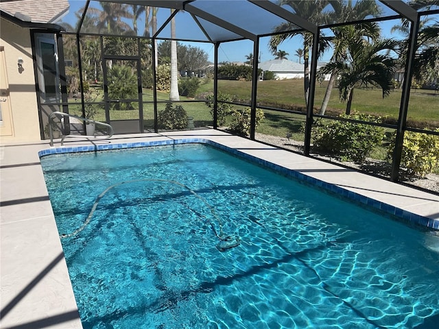 view of swimming pool with glass enclosure