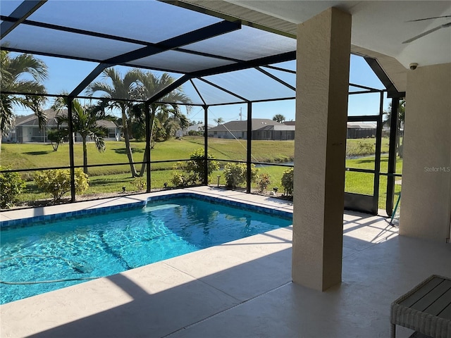 view of pool featuring a patio area, a lanai, and a lawn