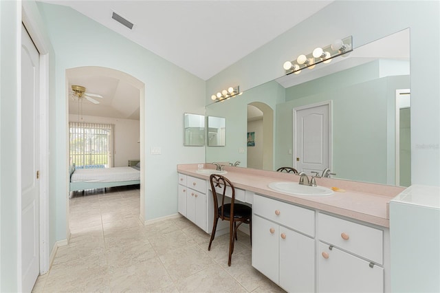 bathroom featuring tile patterned flooring, ceiling fan, lofted ceiling, and vanity