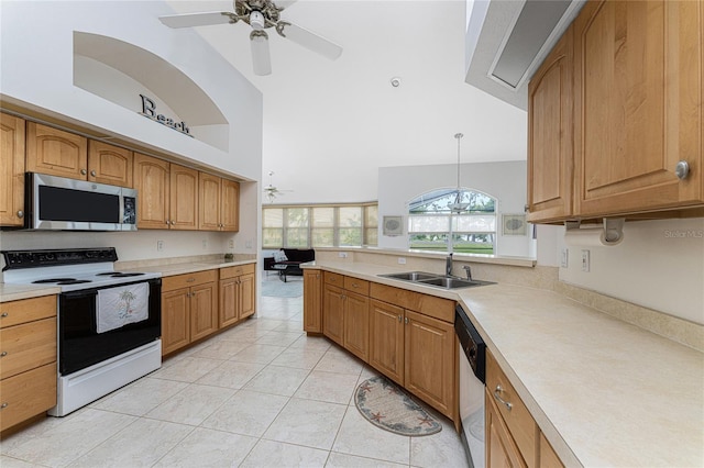 kitchen featuring pendant lighting, light tile patterned floors, stainless steel appliances, and high vaulted ceiling