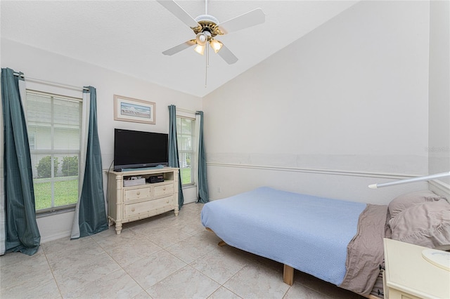 tiled bedroom featuring ceiling fan and lofted ceiling