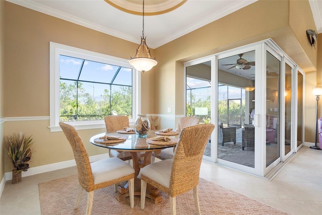 tiled dining space featuring a wealth of natural light, crown molding, and ceiling fan