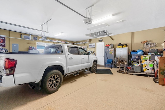 garage with electric panel and a garage door opener