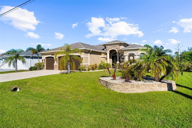 mediterranean / spanish house featuring a front lawn and a garage