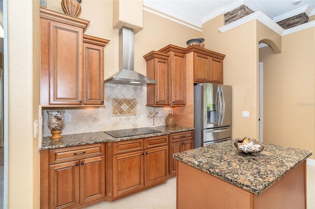 14010 San Domingo Blvd, Port Charlotte, FL 33981 - kitchen featuring stainless steel refrigerator with ice dispenser, wall chimney exhaust hood, stone countertops, brown cabinetry, and crown molding
