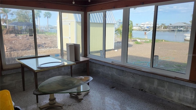 unfurnished sunroom with a water view