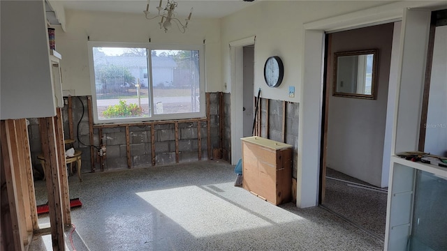 miscellaneous room with a chandelier