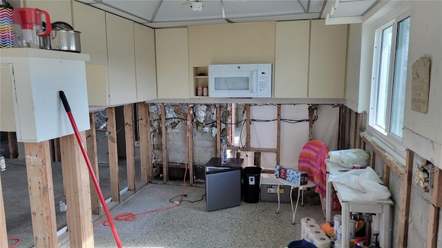 basement featuring stainless steel fridge