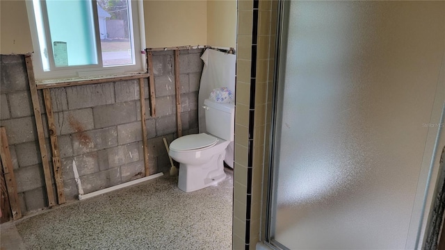 bathroom featuring toilet and walk in shower