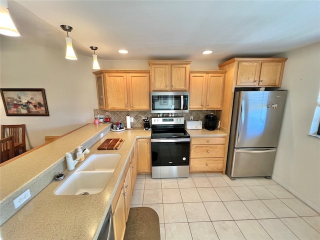 kitchen with backsplash, sink, appliances with stainless steel finishes, decorative light fixtures, and light tile patterned flooring