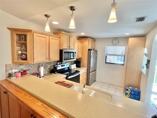 kitchen with pendant lighting, sink, light brown cabinetry, tasteful backsplash, and stainless steel appliances