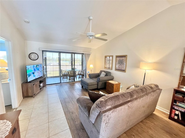 living room with light wood-type flooring, vaulted ceiling, and ceiling fan