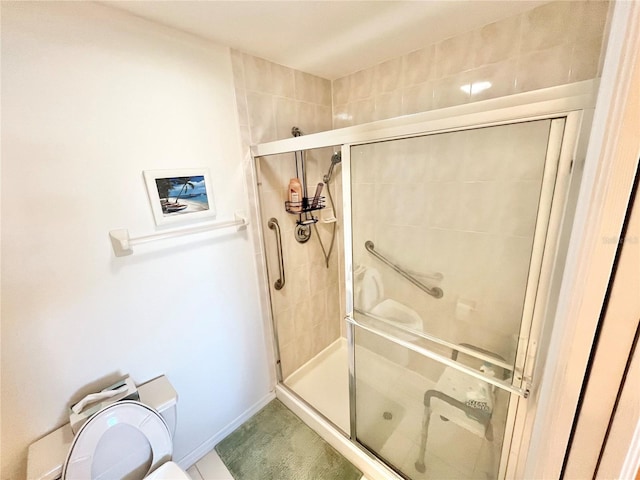 bathroom featuring toilet and walk in shower