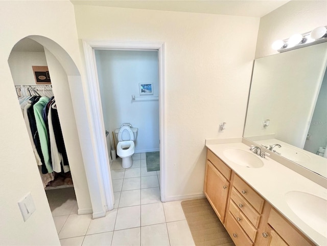 bathroom featuring tile patterned floors, vanity, and toilet