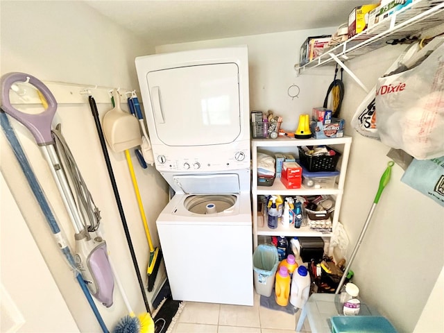 washroom with light tile patterned floors and stacked washer / drying machine