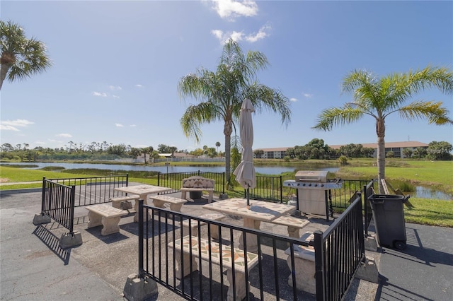 view of patio / terrace with a grill and a water view