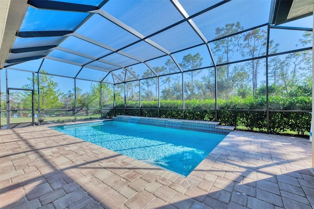 view of swimming pool with glass enclosure and a patio