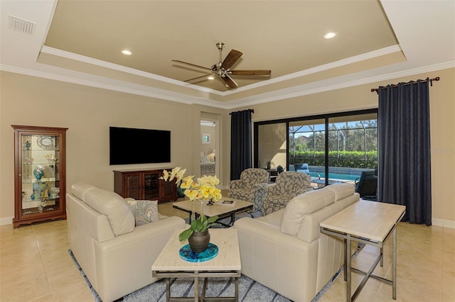 tiled living room with ceiling fan, crown molding, and a tray ceiling