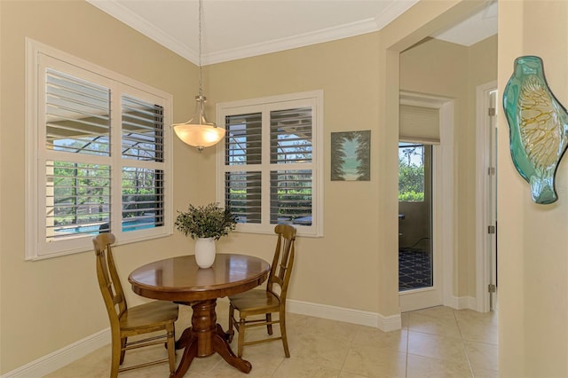 dining space featuring ornamental molding and light tile patterned flooring