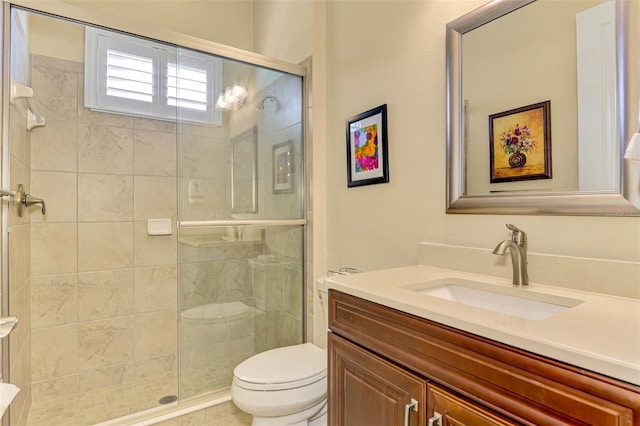 bathroom with vanity, toilet, and a shower with shower door