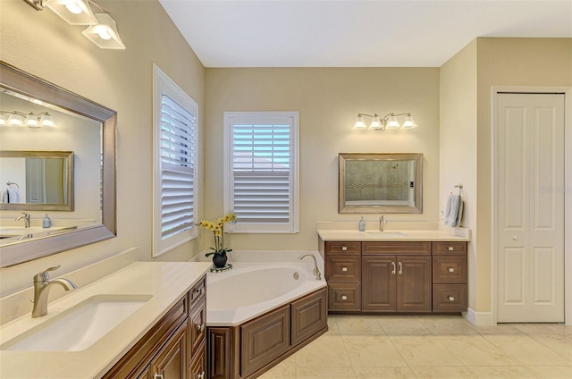 bathroom with tile patterned floors, vanity, and a bathing tub