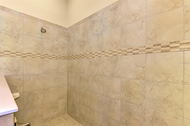 interior space with tiled shower and vanity