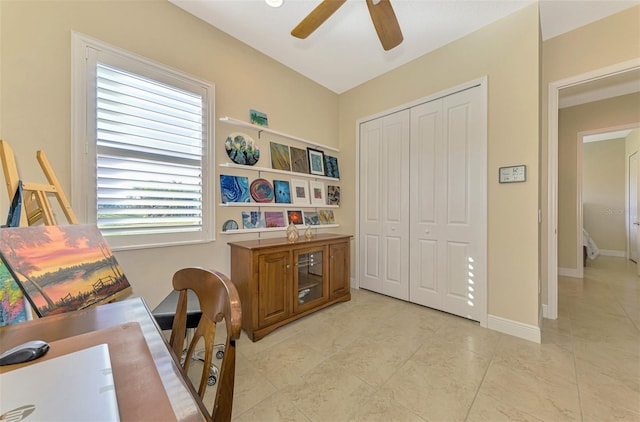 tiled home office with ceiling fan