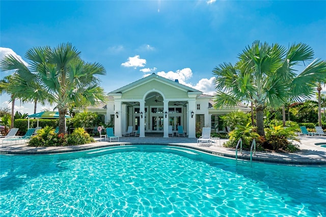 view of pool featuring a patio area and french doors