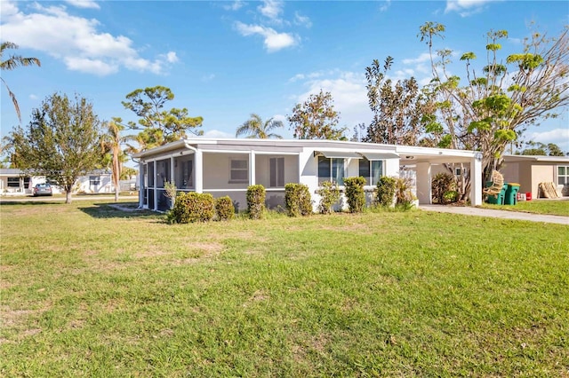 ranch-style home with a carport and a front lawn