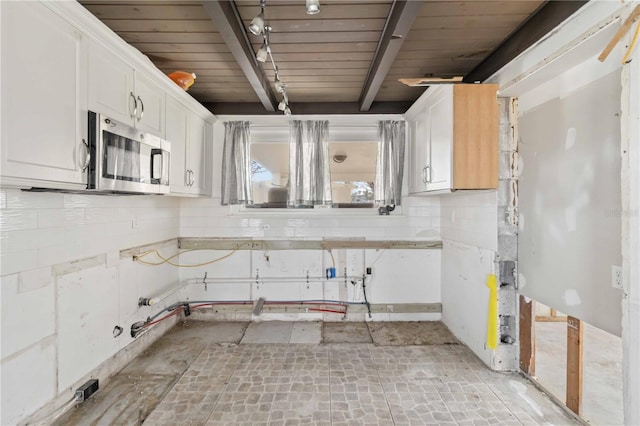 kitchen featuring beam ceiling, white cabinetry, and wood ceiling