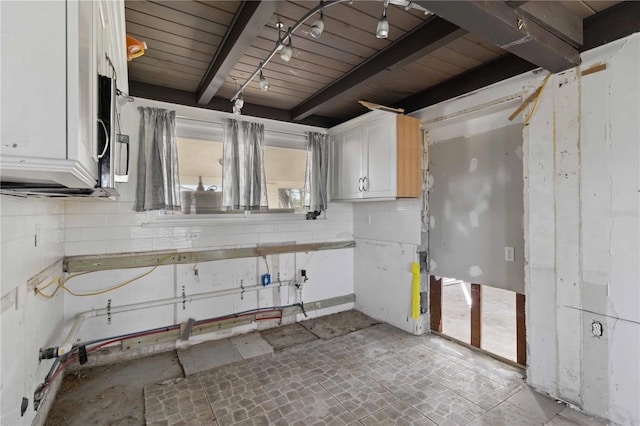 kitchen featuring beam ceiling, white cabinetry, and wooden ceiling